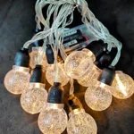 Guirnalda 10 led - Bolita transparente (burbujas) con cabezal negro (AA) - Cálido